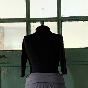 Velvet turtleneck top with 3/4 length sleeves.